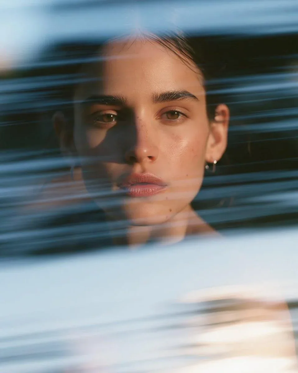 Ultra-realistic cinematic close-up portrait of a beautiful young woman with sleek dark hair pulled into a cle… - AI提示词参考图，来自西西提示词