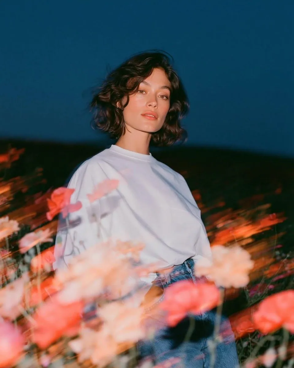 Create a cinematic fashion editorial portrait at blue hour in an open wildflower field. A beautiful young wom… - AI提示词参考图，来自西西提示词