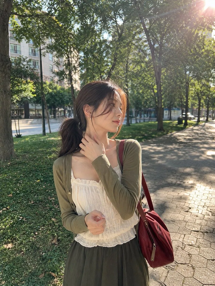 A photorealistic candid outdoor portrait of a young woman standing in a peaceful urban park on a sunny aftern… - AI提示词参考图，来自西西提示词