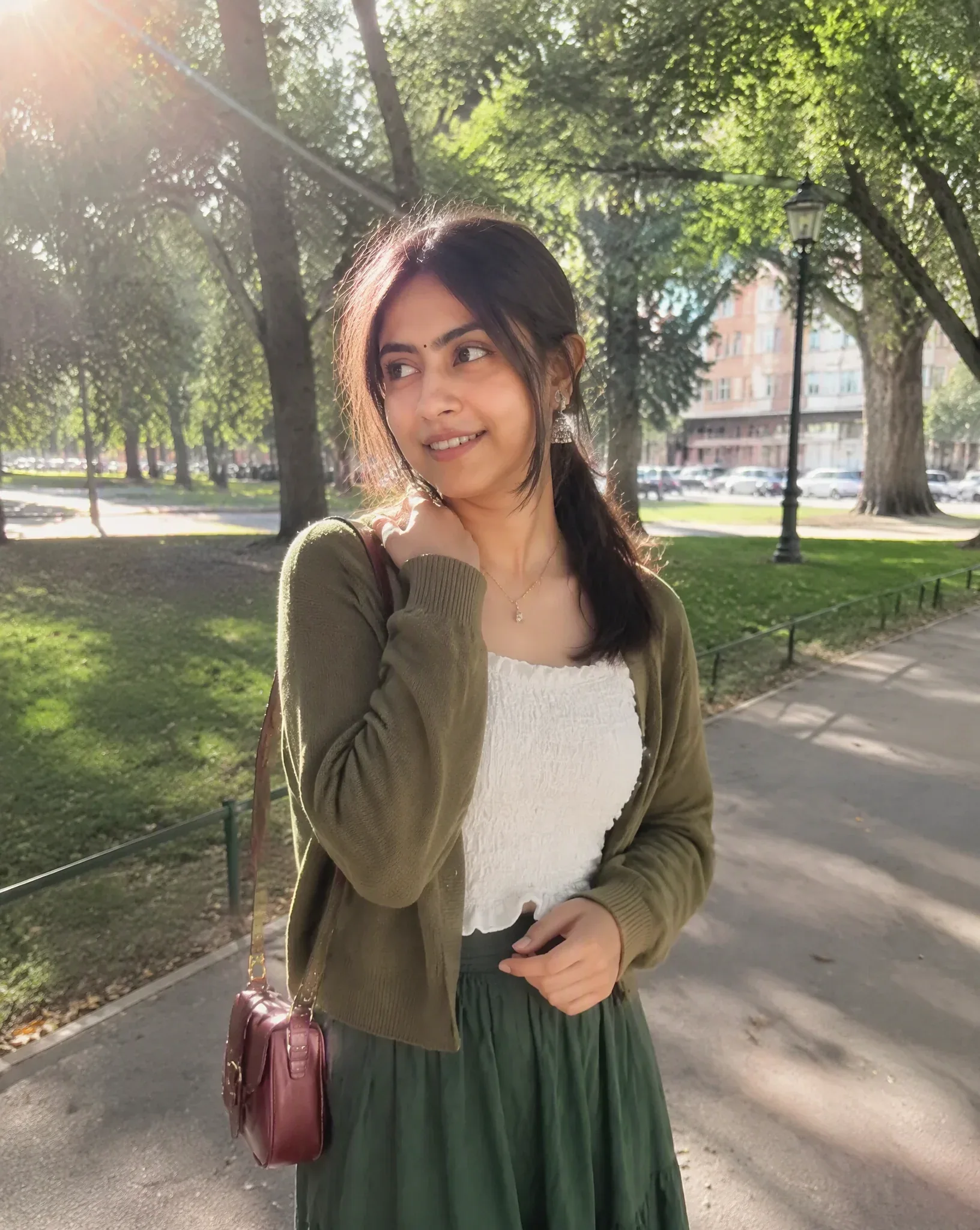 A photorealistic candid outdoor portrait of a young woman standing in a peaceful urban park on a sunny aftern… - AI提示词参考图，来自西西提示词
