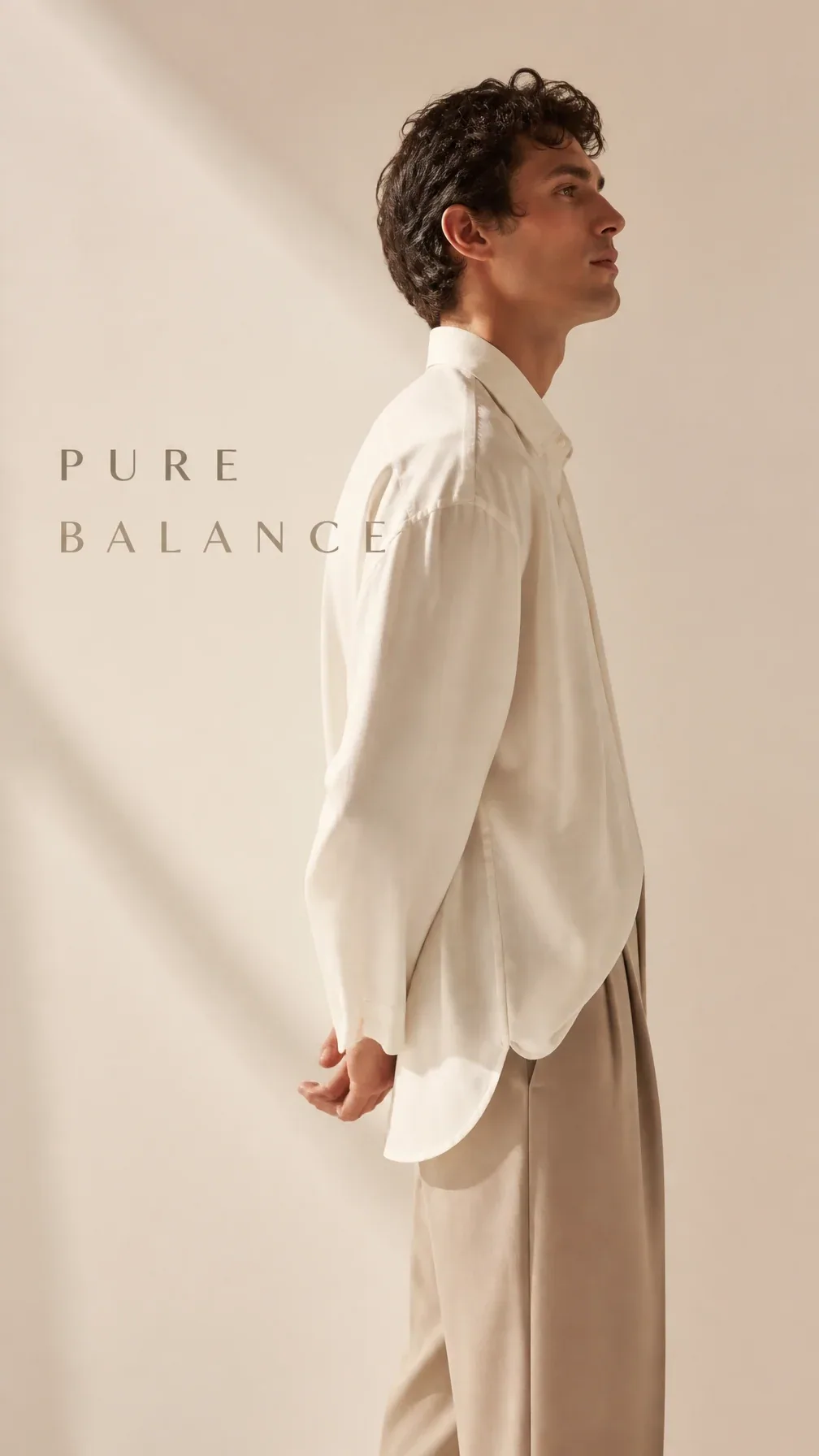 Premium minimalist fashion campaign. Main Subject: Male model wearing an oversized ivory shirt with tailored … - AI提示词参考图，来自西西提示词