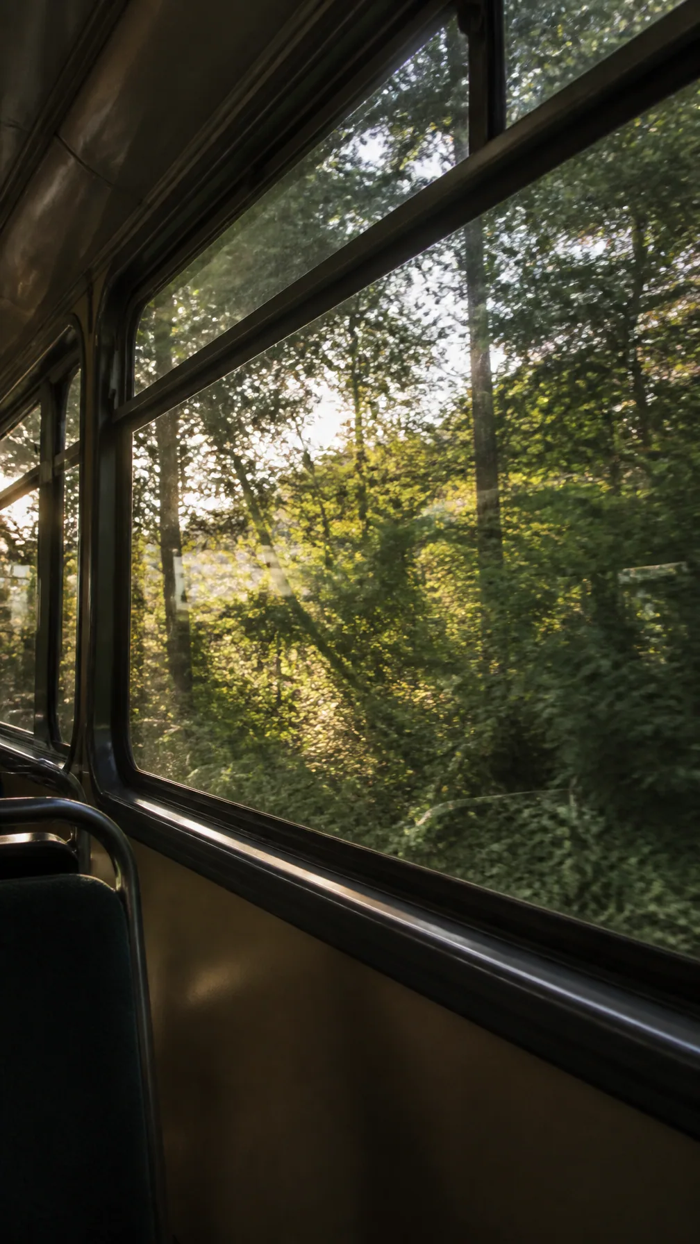 Ultra-realistic emotional fine-art film photograph taken from inside an empty vintage train or bus, looking t… - AI提示词参考图，来自西西提示词
