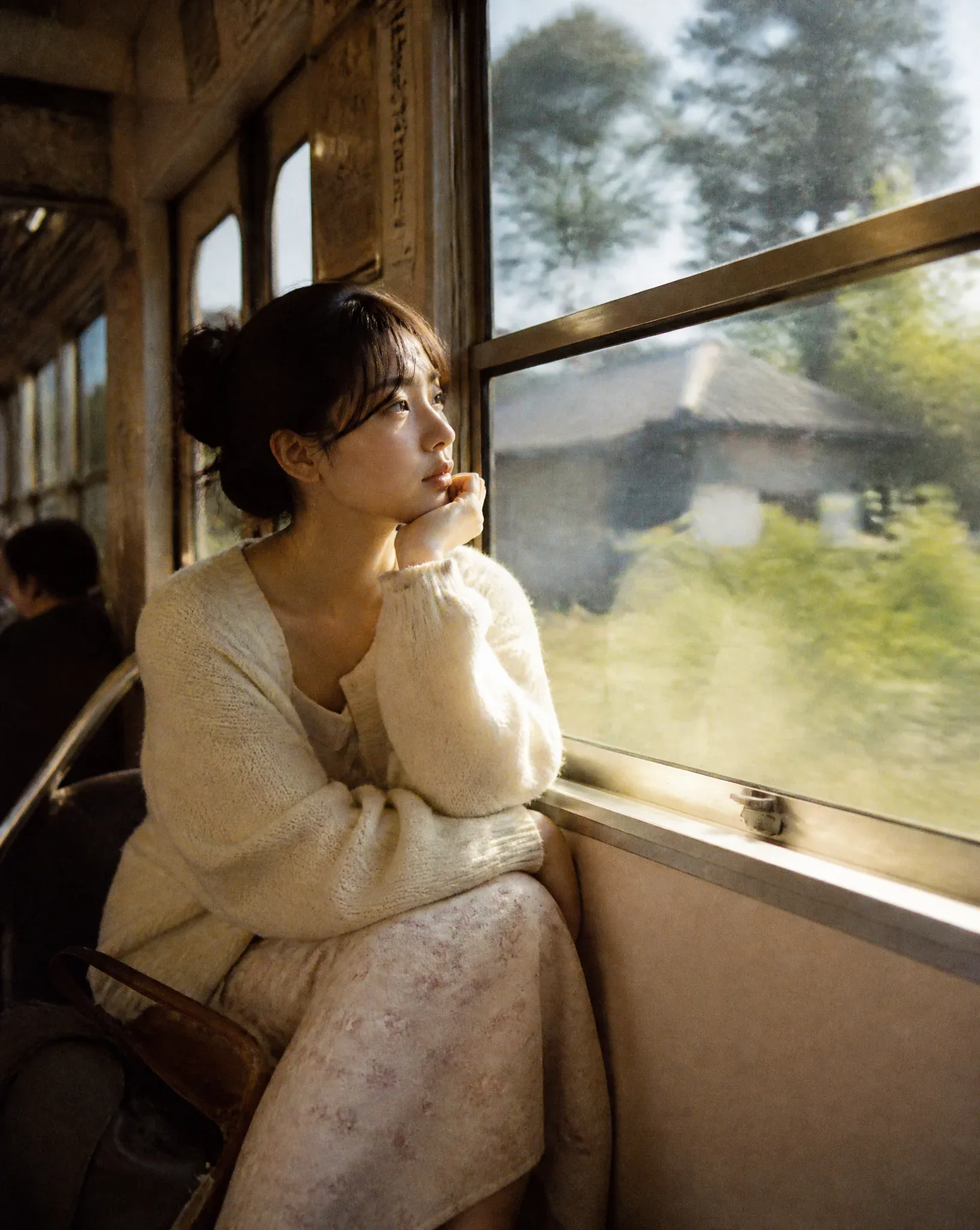 A beautiful Japanese woman sitting beside the window inside an old local train crossing the countryside, over… - AI提示词参考图，来自西西提示词
