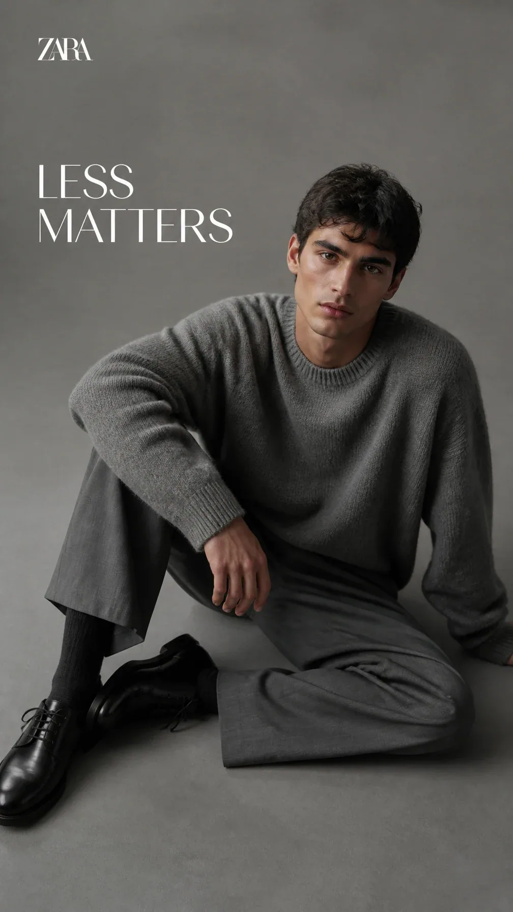 Luxury menswear editorial. Main Subject: Young male model wearing an oversized stone-grey knit sweater. Pose:… - AI prompt reference from CC Prompt Galaxy