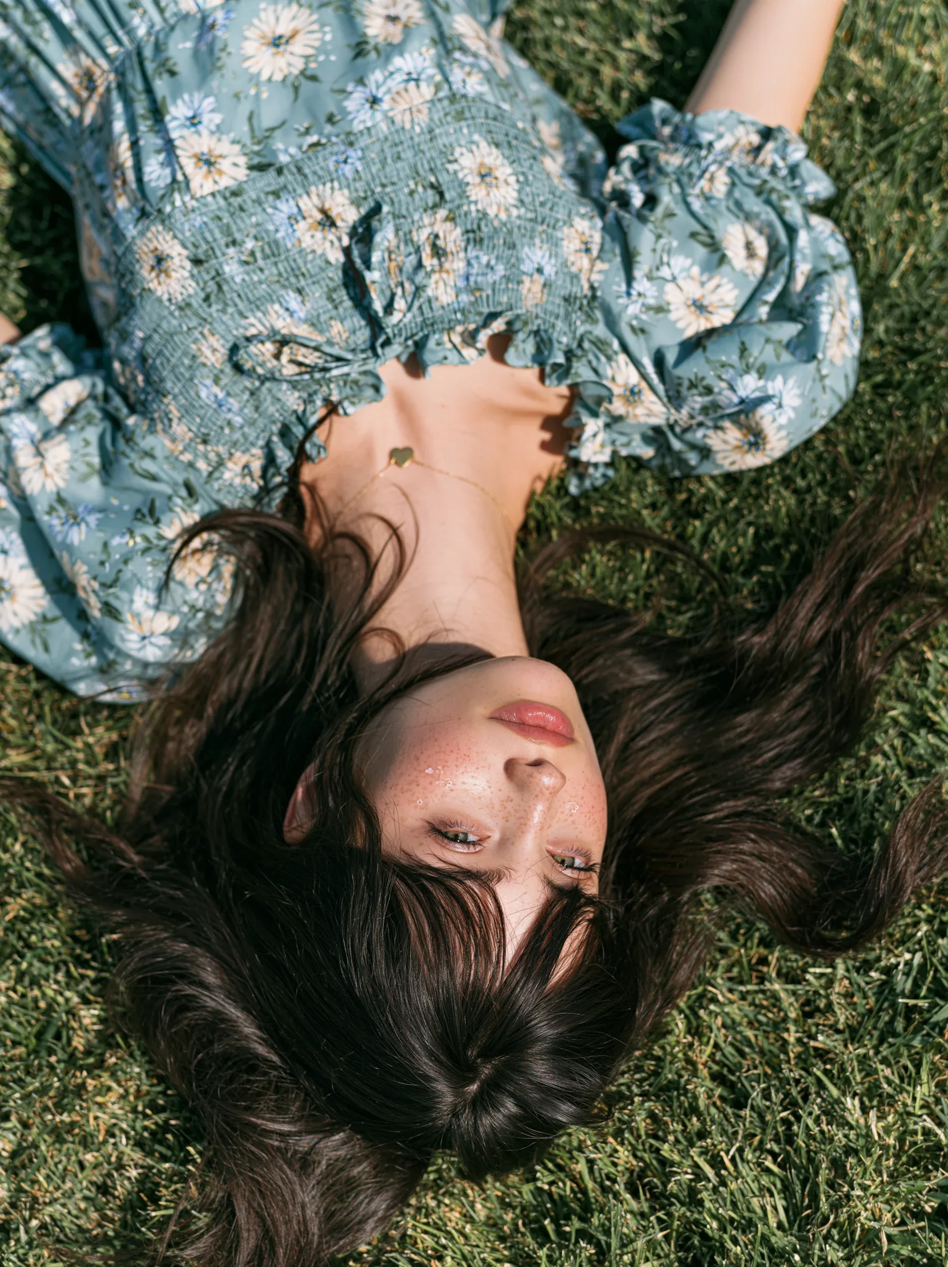 top angle shot of a pretty woman lying on a manicured lawn. woman's is splayed around her, face has cute make… - AI提示词参考图，来自西西提示词