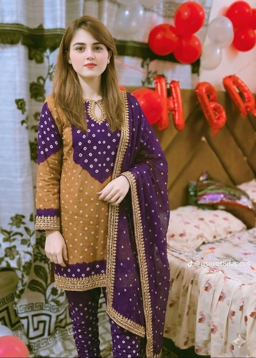 Create a realistic vertical portrait photo of a beautiful young South Asian woman standing beside a bed in a … - AI prompt reference from CC Prompt Galaxy