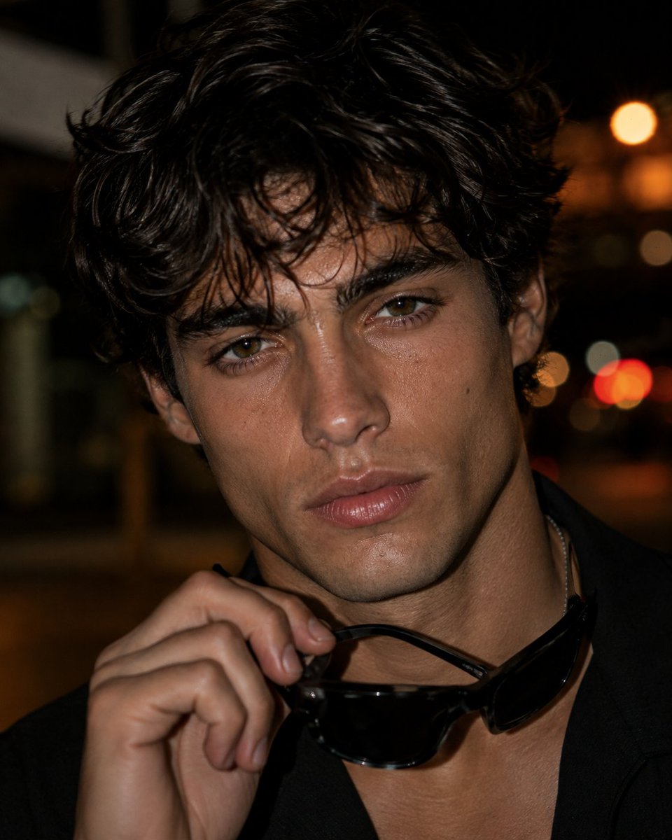Photorealistic close-up editorial portrait of a {argument name="subject" default="young adult man with short,… - AI提示词参考图，来自西西提示词