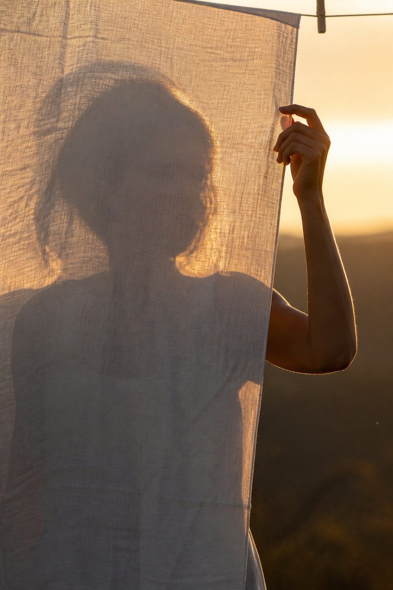Create a vertical photorealistic portrait at golden hour of {argument name="subject" default="a woman"} stand… - AI提示词参考图，来自西西提示词