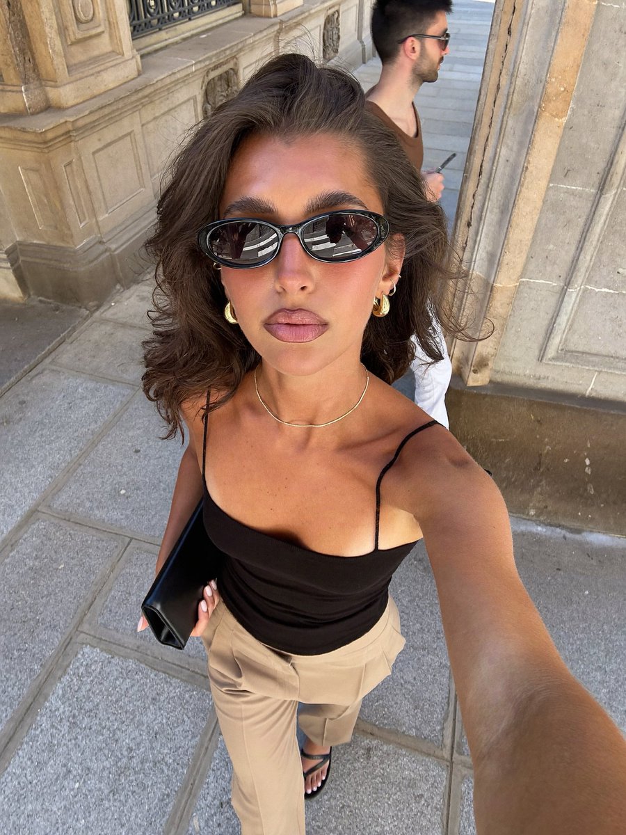 A high-angle, close-up selfie captures a young adult {argument name="ethnicity" default="woman of Mediterrane… - AI提示词参考图，来自西西提示词